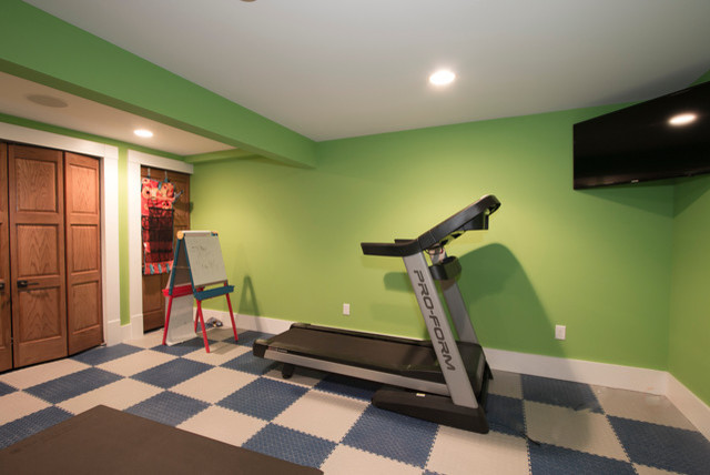 Photo of a mid-sized contemporary home weight room in Chicago with green walls and multi-coloured floor.