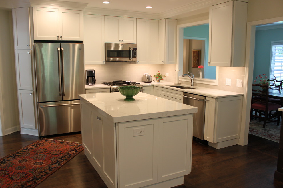 Enclosed kitchen - mid-sized transitional l-shaped dark wood floor and brown floor enclosed kitchen idea in Chicago with an undermount sink, recessed-panel cabinets, white cabinets, quartzite countertops, white backsplash, subway tile backsplash, stainless steel appliances and an island