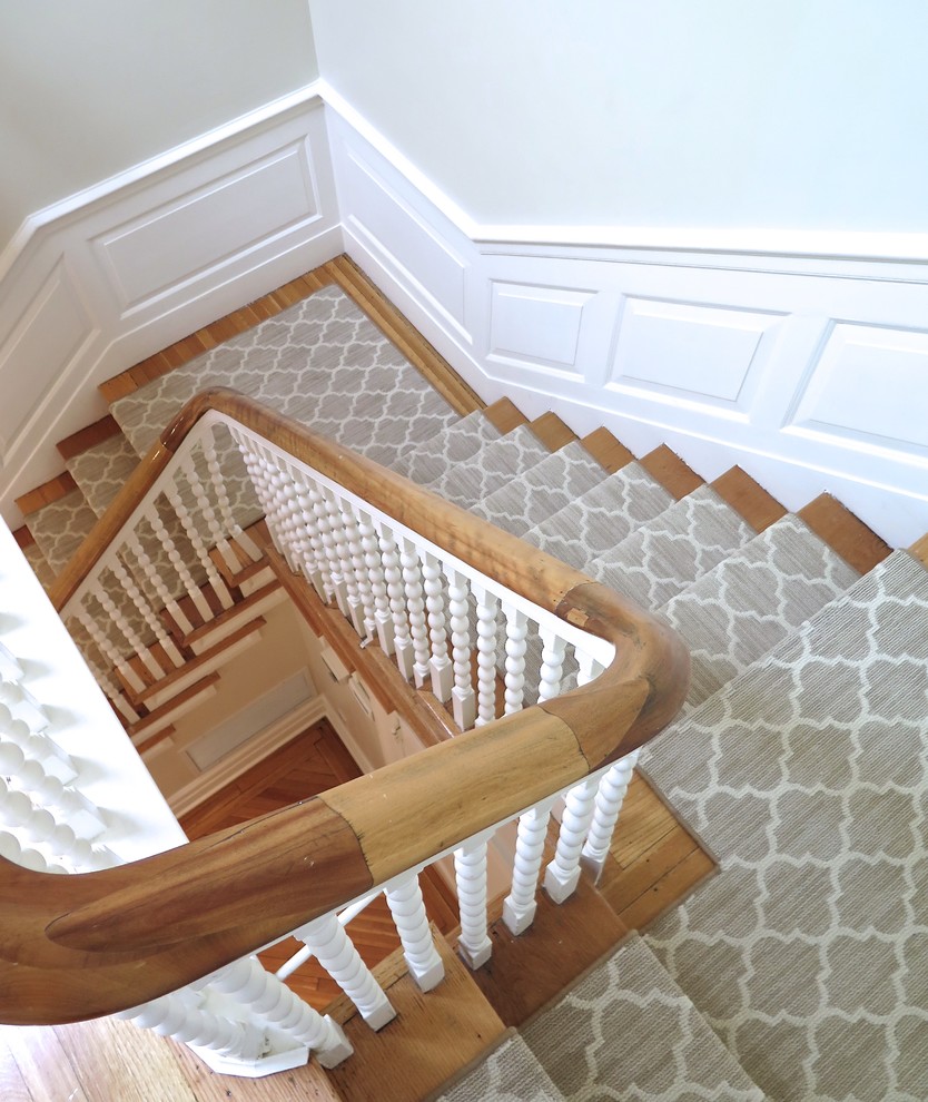 Design ideas for a large traditional carpeted u-shaped staircase in Montreal with carpet risers.