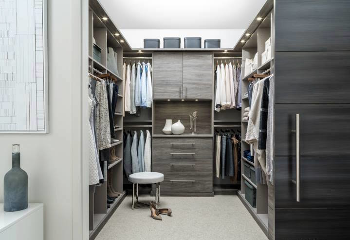 Inspiration for a mid-sized transitional gender-neutral walk-in wardrobe in Grand Rapids with flat-panel cabinets, grey cabinets, carpet and beige floor.