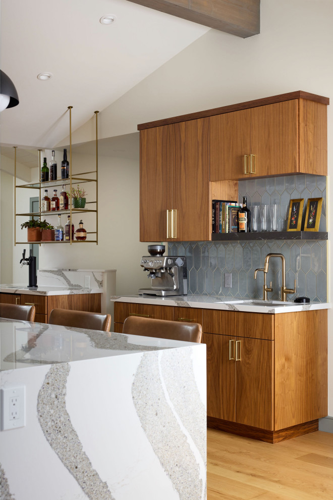 Kitchen - large eclectic medium tone wood floor, brown floor and vaulted ceiling kitchen idea with a drop-in sink, flat-panel cabinets, medium tone wood cabinets, quartz countertops, blue backsplash, ceramic backsplash, stainless steel appliances, an island and white countertops