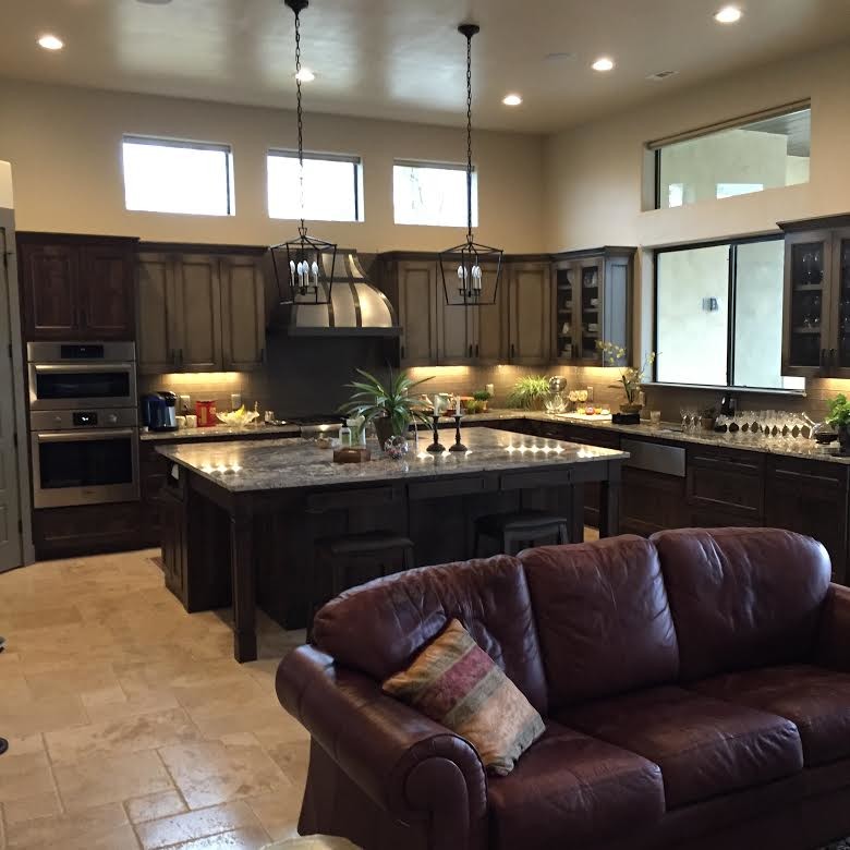 Eat-in kitchen - mid-sized rustic l-shaped ceramic tile eat-in kitchen idea in Austin with an undermount sink, shaker cabinets, dark wood cabinets, granite countertops, beige backsplash, ceramic backsplash, stainless steel appliances and an island