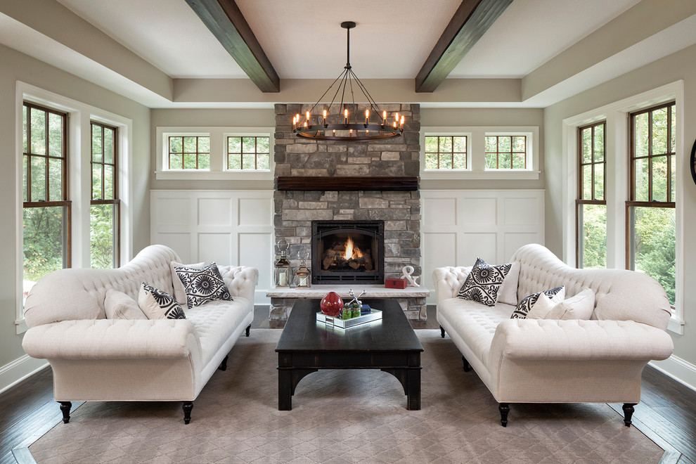 Inspiration for a traditional formal living room in Minneapolis with grey walls, a wood stove and a stone fireplace surround.