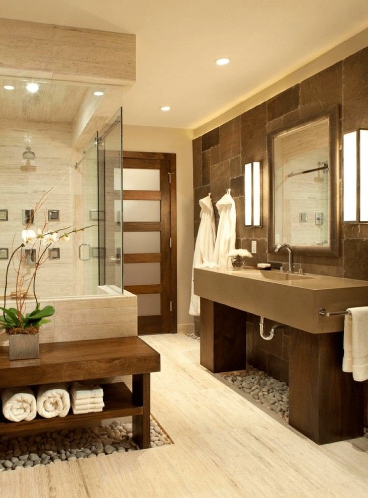 Inspiration for a large asian master wet room bathroom in San Francisco with brown tile, stone tile, beige walls, porcelain floors, an integrated sink, engineered quartz benchtops, beige floor and a hinged shower door.