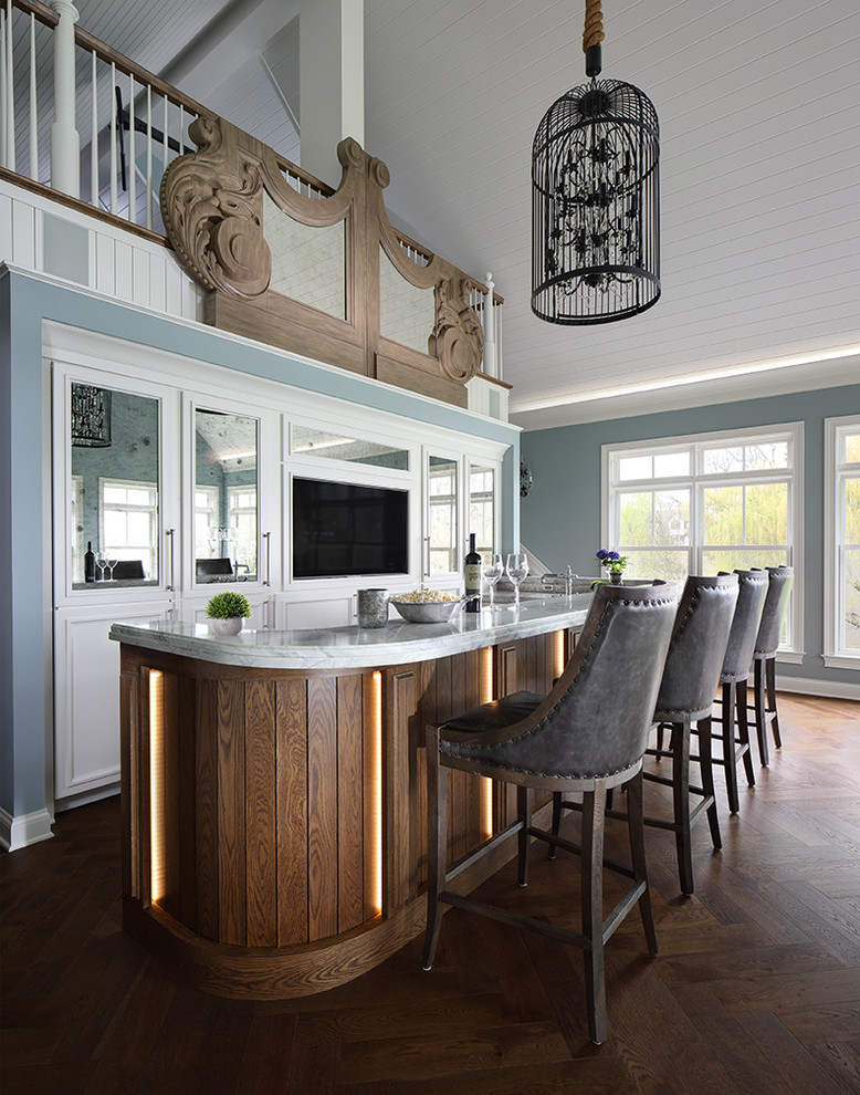 Country seated home bar in Milwaukee with white cabinets, medium hardwood floors, brown floor and grey benchtop.