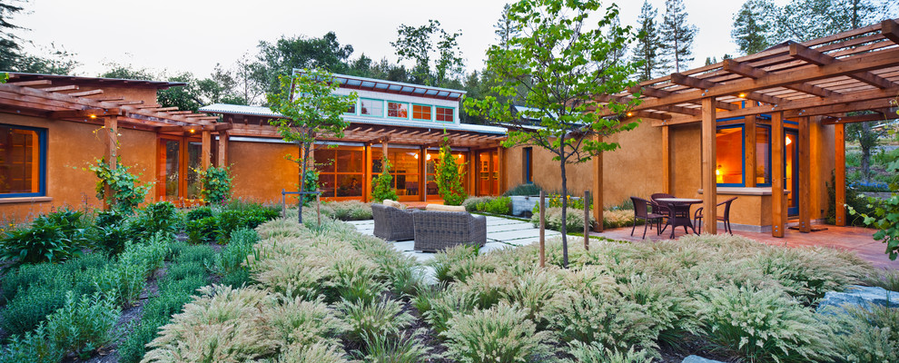 Photo of a mid-sized contemporary courtyard patio in San Francisco with a water feature, concrete pavers and a pergola.