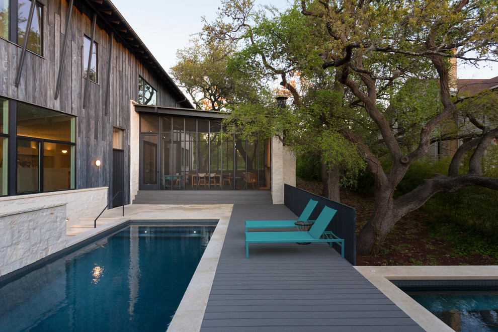 Inspiration for a mid-sized modern courtyard rectangular lap pool in Austin with a hot tub and decking.
