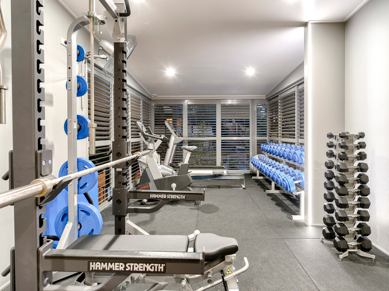 This is an example of a mid-sized industrial multipurpose gym in Tampa with white walls.