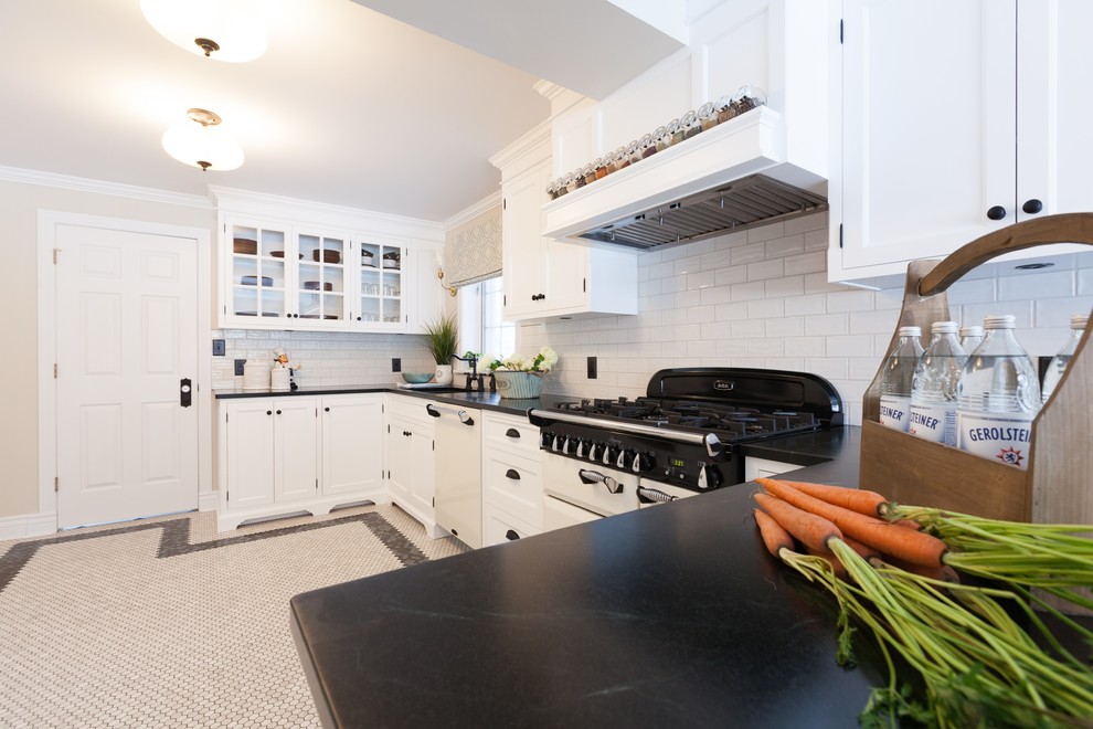 Inspiration for a mid-sized traditional galley separate kitchen in Edmonton with an undermount sink, shaker cabinets, white cabinets, soapstone benchtops, white splashback, porcelain splashback, coloured appliances, porcelain floors, multi-coloured floor and no island.