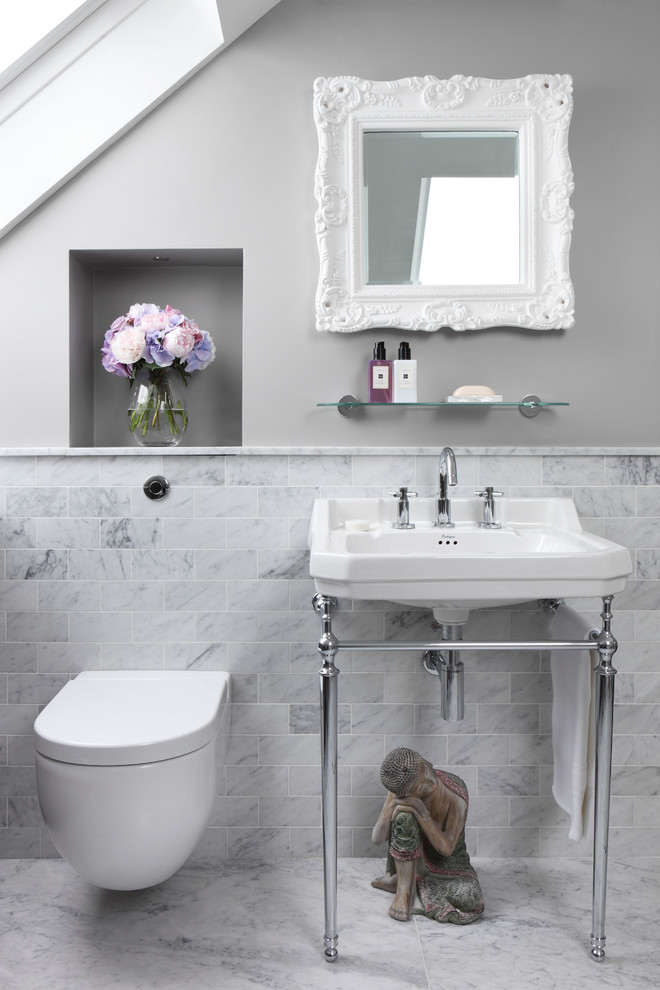Photo of a small traditional bathroom in London with a wall-mount toilet, gray tile, subway tile, grey walls, marble floors and a console sink.