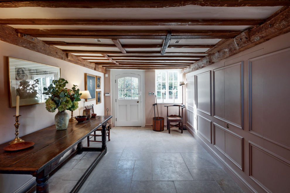 This is an example of a mid-sized country entryway in Oxfordshire with exposed beam.