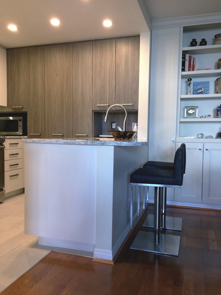 Small contemporary u-shaped eat-in kitchen in Vancouver with an undermount sink, flat-panel cabinets, quartz benchtops, panelled appliances and a peninsula.