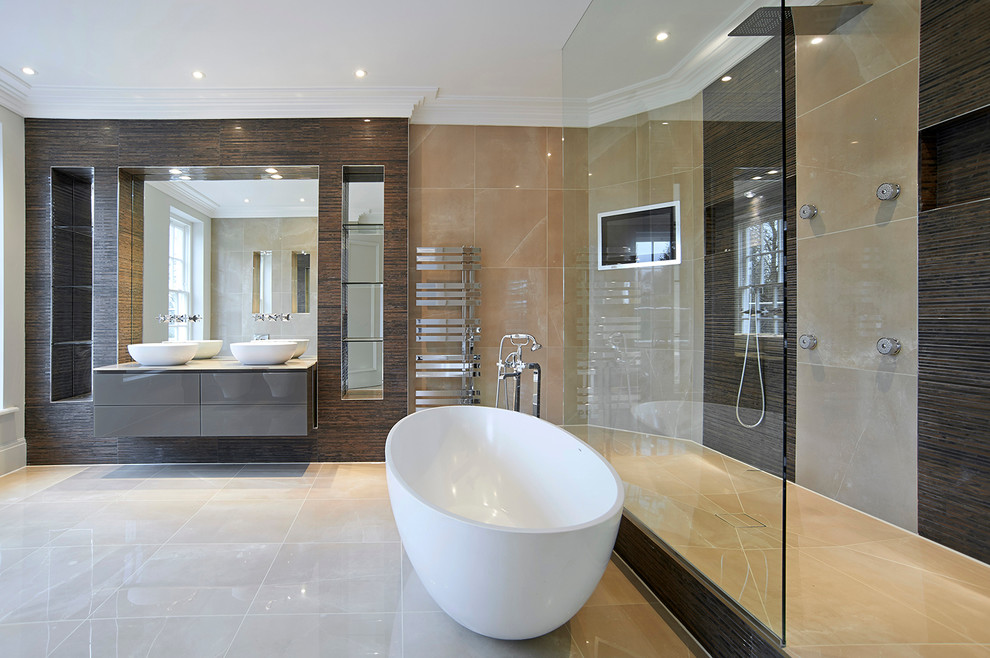 Large contemporary bathroom in London with a console sink, grey cabinets, a curbless shower and a freestanding tub.