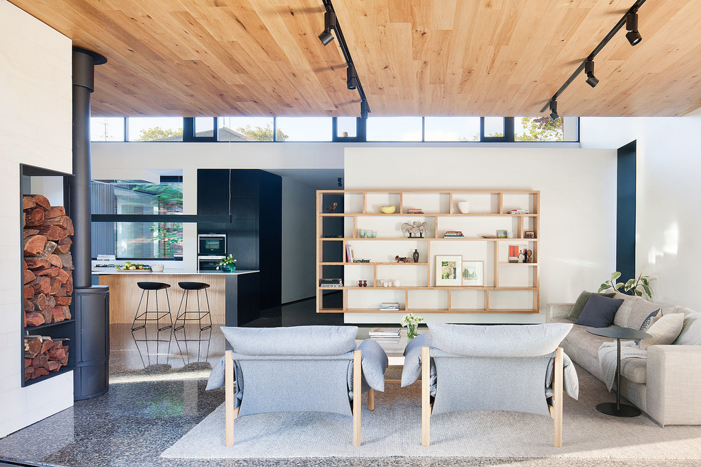 This is an example of a mid-sized open concept living room in Melbourne with white walls.