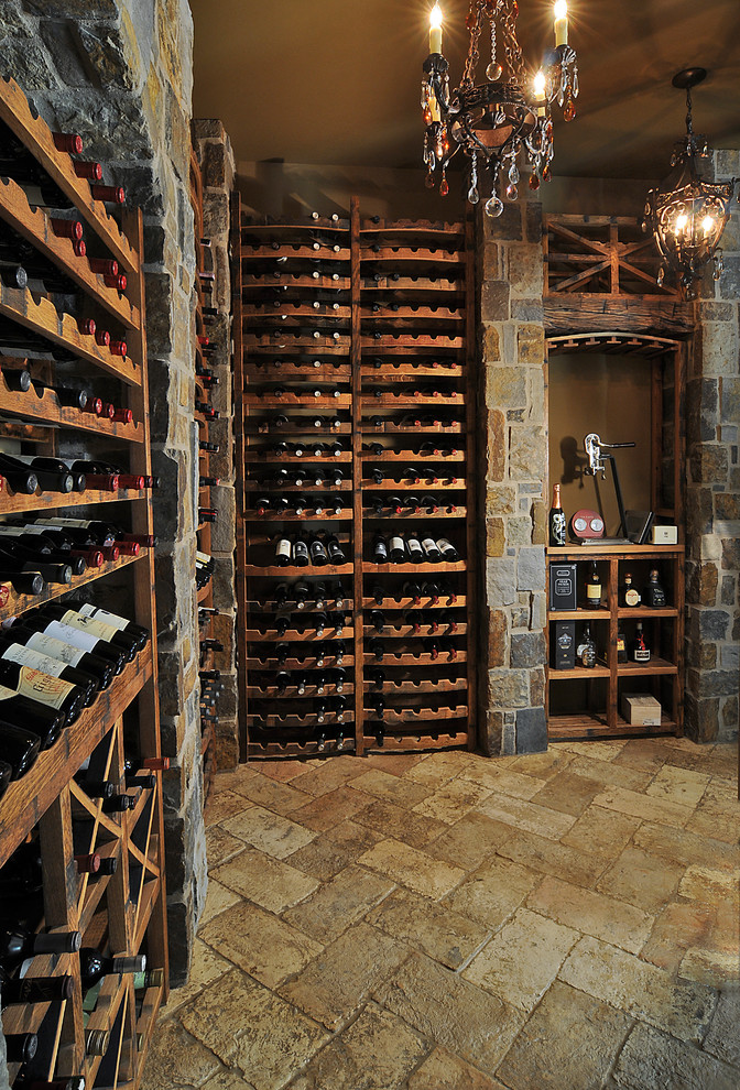 Photo of a large traditional wine cellar in Phoenix with limestone floors, storage racks and beige floor.