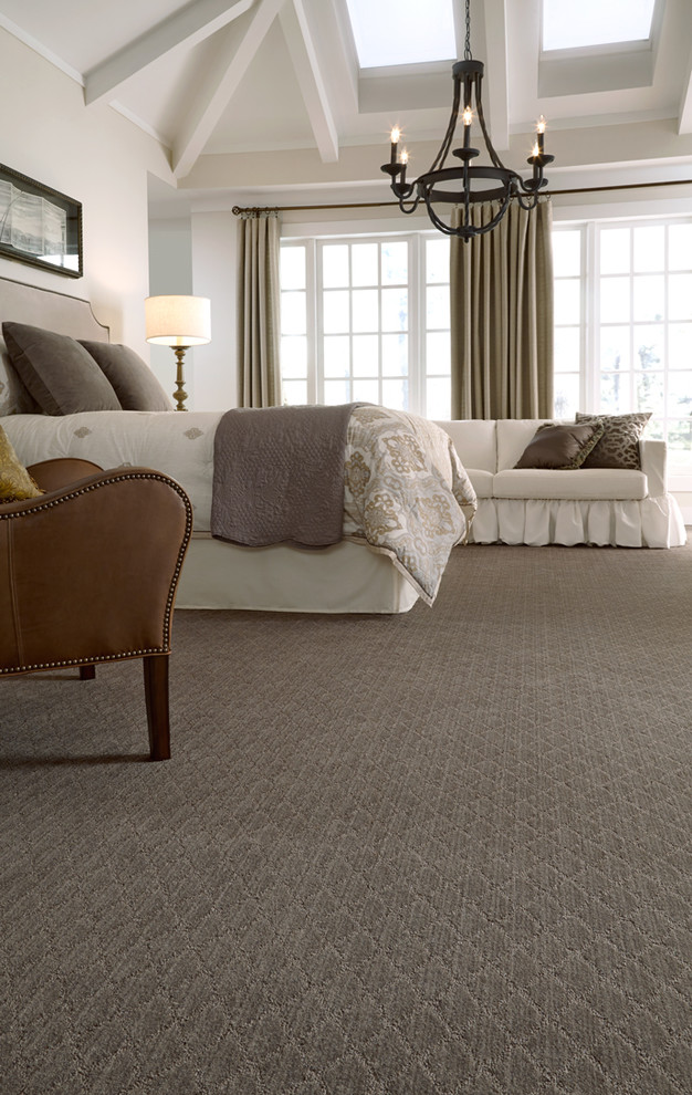 Inspiration for a large traditional master bedroom in Calgary with grey walls, carpet and grey floor.