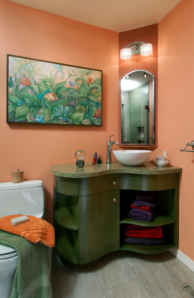 Photo of a mid-sized midcentury 3/4 bathroom in Boise with furniture-like cabinets, green cabinets, an alcove shower, a one-piece toilet, pink walls, a vessel sink, grey floor, a hinged shower door and green benchtops.