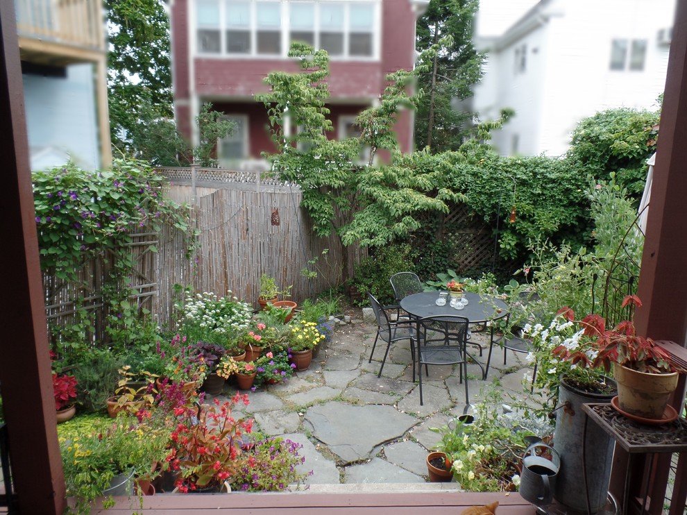 Inspiration for a small traditional backyard patio in Other with natural stone pavers and no cover.