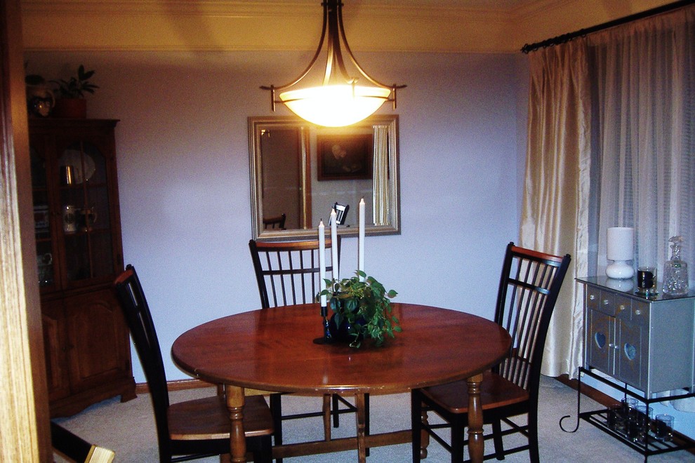 Example of a small transitional dining room design with blue walls