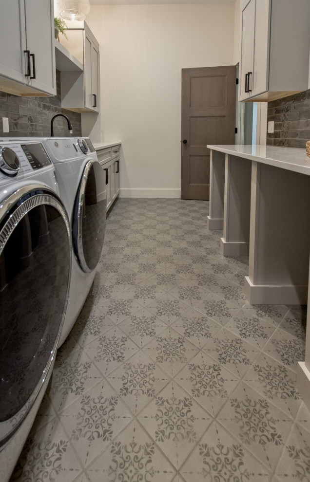 Transitional galley ceramic tile and gray floor dedicated laundry room photo in Other with flat-panel cabinets, white cabinets, quartz countertops, black backsplash, subway tile backsplash, white walls, a side-by-side washer/dryer and white countertops