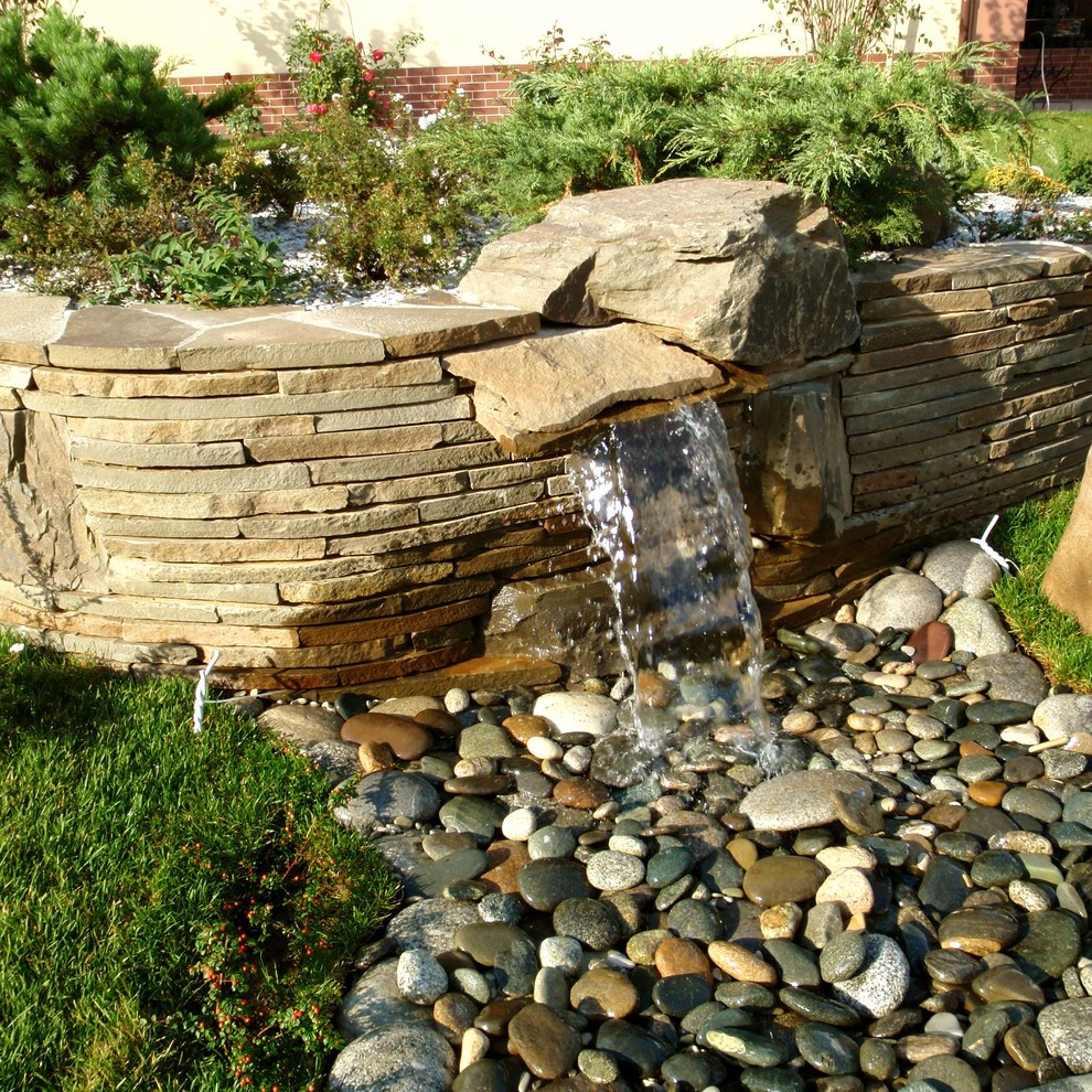 This is an example of a traditional garden for summer in Moscow with a water feature.