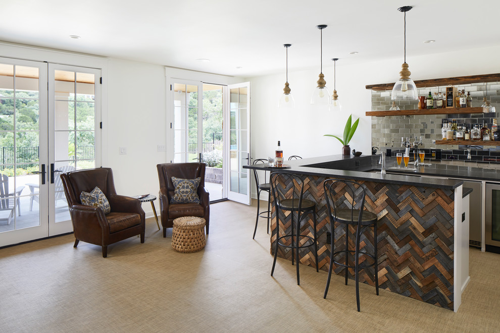 This is an example of an expansive beach style u-shaped seated home bar in Austin with open cabinets, granite benchtops, vinyl floors, beige floor, black benchtop and metal splashback.