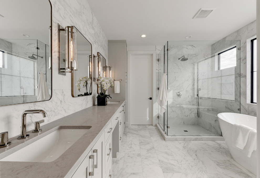 Photo of a transitional bathroom in Austin with shaker cabinets, white cabinets, a freestanding tub, an undermount sink, white floor and grey benchtops.