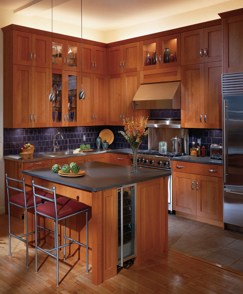 This is an example of a traditional kitchen in Other with stainless steel appliances and blue splashback.