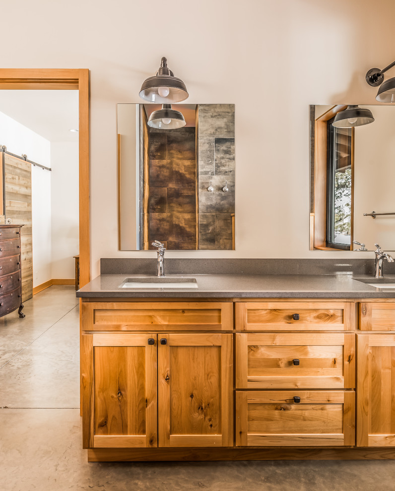 Design ideas for a mid-sized country master bathroom in Seattle with shaker cabinets, brown cabinets, white tile, porcelain tile, white walls, concrete floors, an undermount sink, solid surface benchtops, grey floor and beige benchtops.