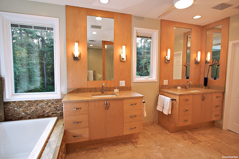 Large transitional master bathroom in Atlanta with an undermount sink, flat-panel cabinets, light wood cabinets, marble benchtops, a drop-in tub, a corner shower, a two-piece toilet, beige tile, stone tile, beige walls and travertine floors.