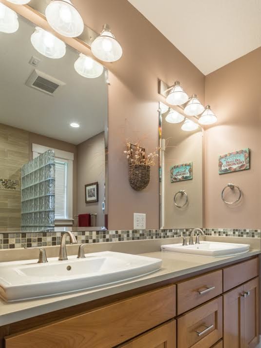 This is an example of a large transitional master bathroom in Portland with shaker cabinets, medium wood cabinets, beige walls, a drop-in sink and engineered quartz benchtops.