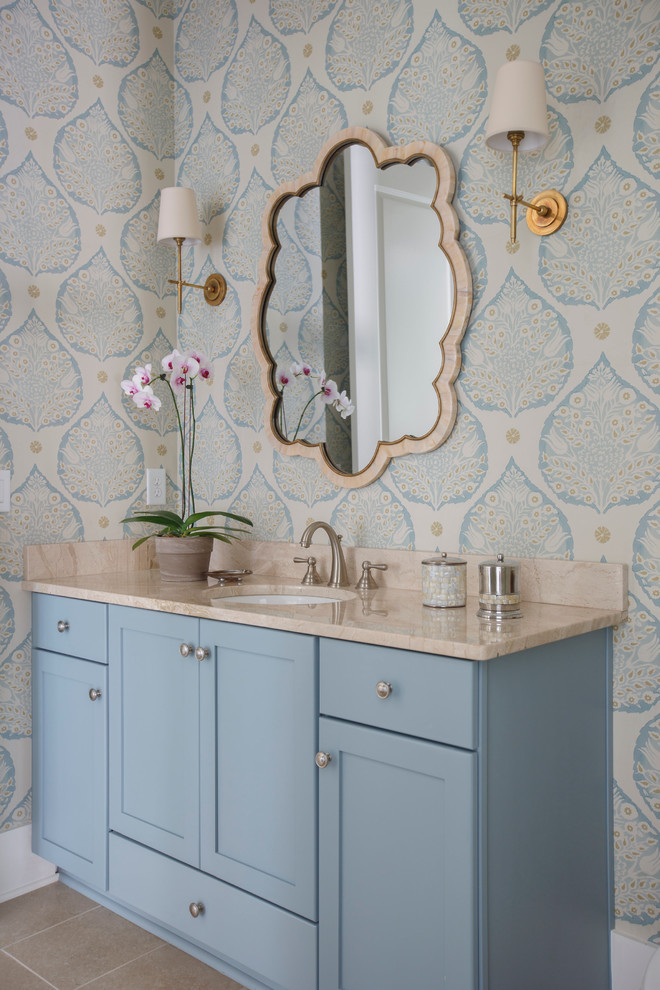 Mid-sized traditional 3/4 bathroom in Jacksonville with blue cabinets, beige tile, porcelain tile, an undermount sink, marble benchtops, shaker cabinets, multi-coloured walls and porcelain floors.