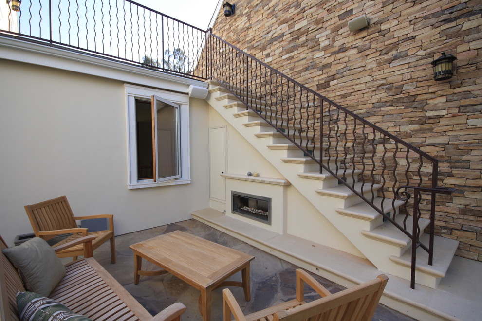 Photo of an arts and crafts patio in San Luis Obispo with natural stone pavers and no cover.