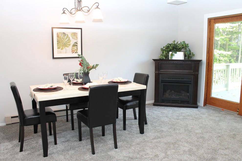 Transitional carpeted and gray floor great room photo in New York with gray walls and a corner fireplace