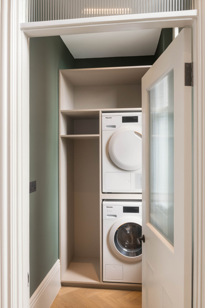 This is an example of a transitional laundry room in London.