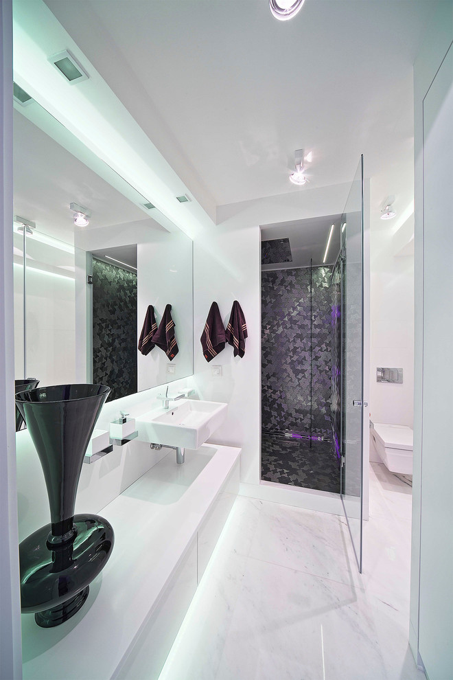 Inspiration for a mid-sized contemporary 3/4 bathroom in Moscow with flat-panel cabinets, white cabinets, a wall-mount toilet, metal tile, white walls, marble floors, a wall-mount sink, an alcove shower, white tile and a hinged shower door.