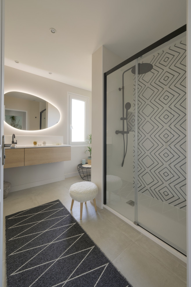 This is an example of a large transitional master bathroom in Montpellier with beaded inset cabinets, light wood cabinets, a drop-in tub, an alcove shower, black and white tile, ceramic tile, beige walls, ceramic floors, a console sink, laminate benchtops, beige floor, an open shower and white benchtops.