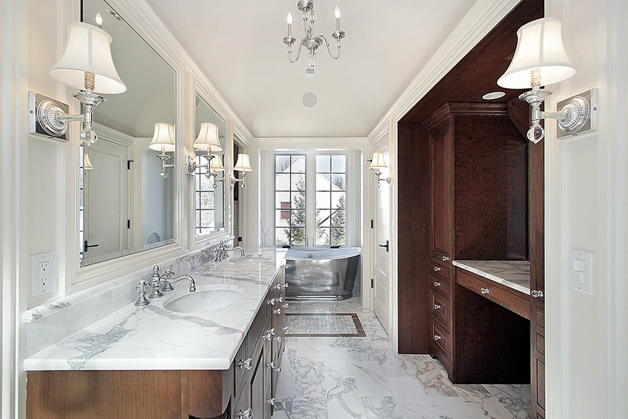 Photo of a large traditional master bathroom in New York with dark wood cabinets, a freestanding tub, white walls, marble floors, an undermount sink, marble benchtops and white floor.