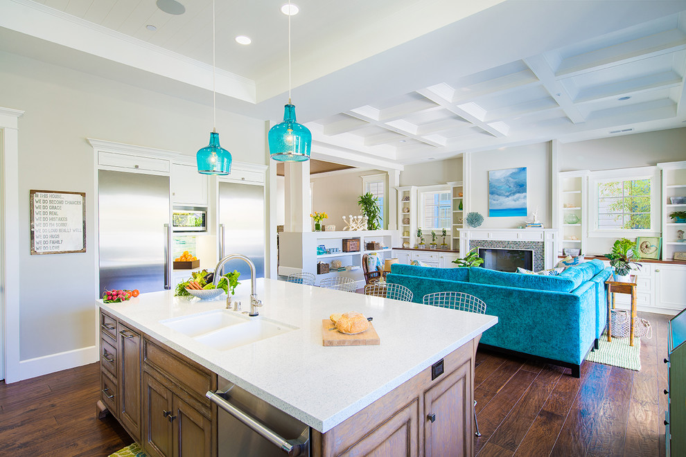 Family room - coastal open concept medium tone wood floor family room idea in Los Angeles with white walls, a standard fireplace, a tile fireplace and no tv