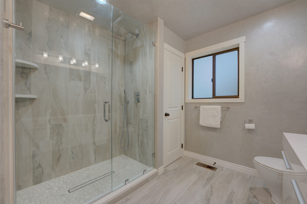 Photo of a large ensuite bathroom in Jacksonville with all types of shower, beige tiles, porcelain tiles, white walls, porcelain flooring, beige floors and a hinged door.