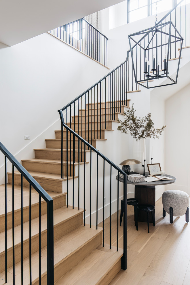Inspiration for a large transitional wood l-shaped staircase in Phoenix with wood risers and metal railing.