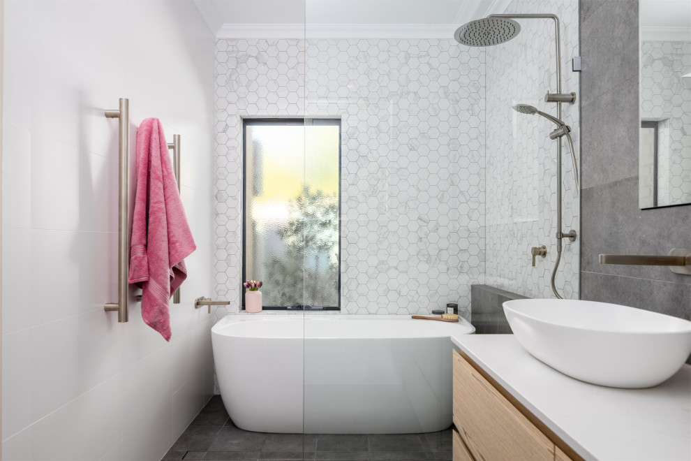 Mid-sized contemporary wet room bathroom in Perth with flat-panel cabinets, light wood cabinets, a freestanding tub, engineered quartz benchtops, an open shower, white benchtops, a double vanity, a floating vanity, white tile, a vessel sink and grey floor.
