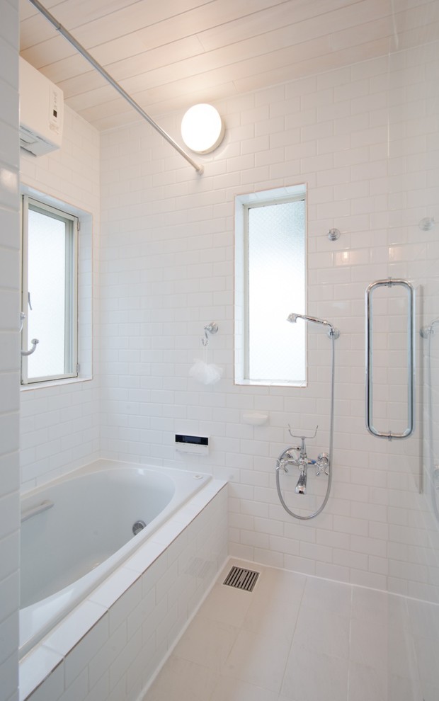 Arts and crafts bathroom in Other with white tile and subway tile.
