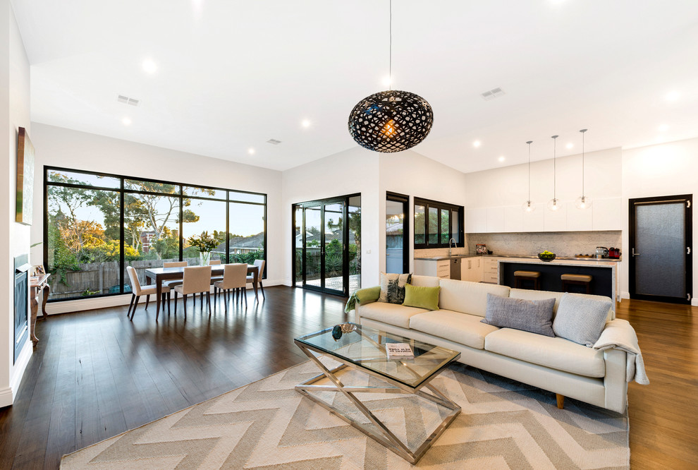 Mid-sized contemporary open concept living room in Melbourne with white walls and medium hardwood floors.