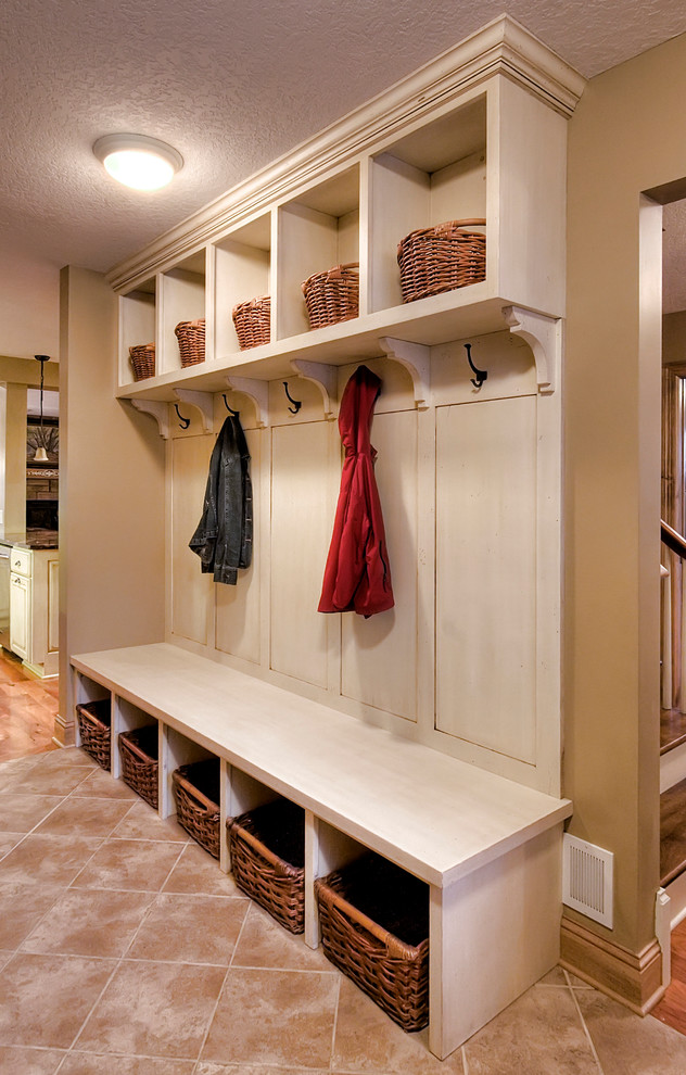 Inspiration for a small traditional mudroom in Minneapolis with brown walls and ceramic floors.