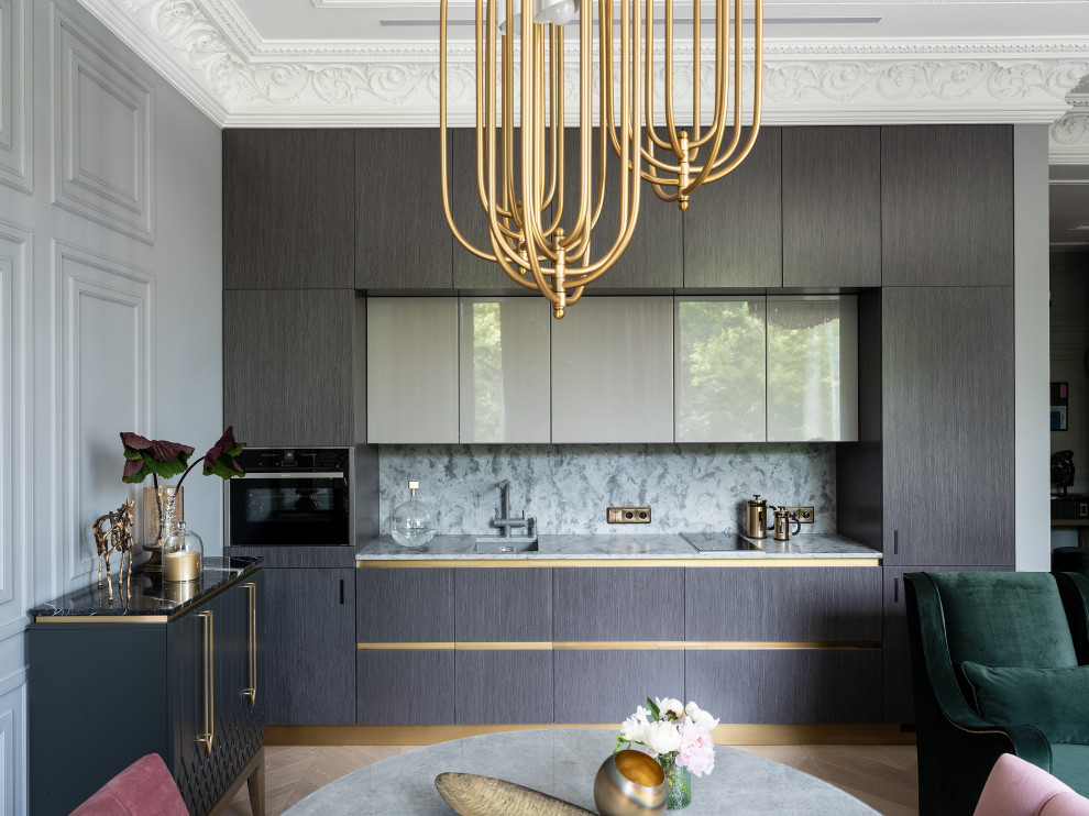 This is an example of a mid-sized contemporary single-wall eat-in kitchen in Moscow with flat-panel cabinets, grey cabinets, black appliances, no island, beige floor, an undermount sink, grey splashback, stone slab splashback, light hardwood floors and grey benchtop.