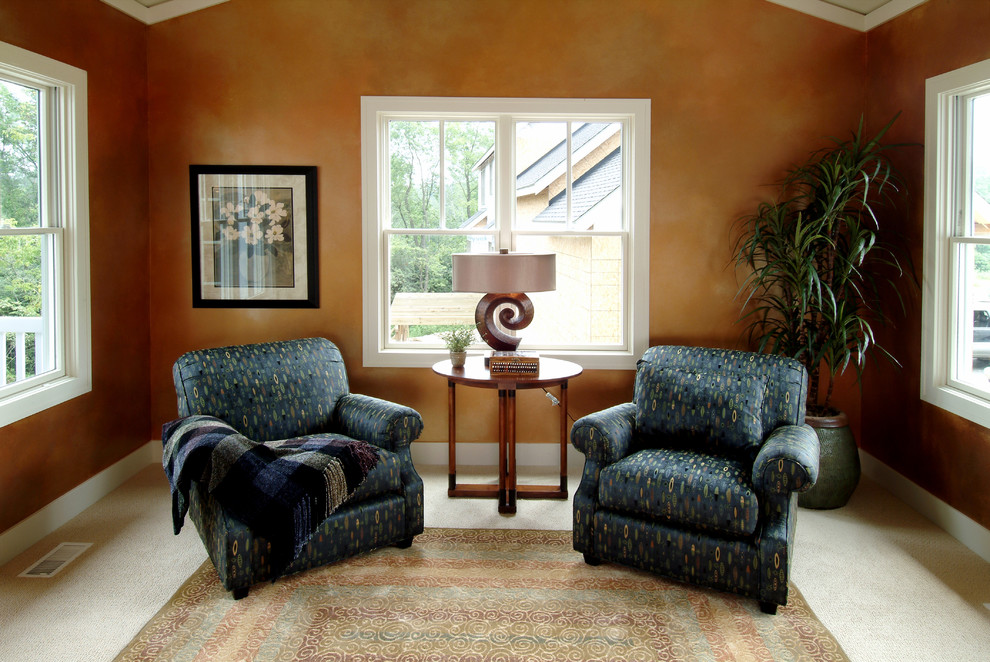 Family room - mid-sized traditional enclosed carpeted family room idea in Grand Rapids with beige walls