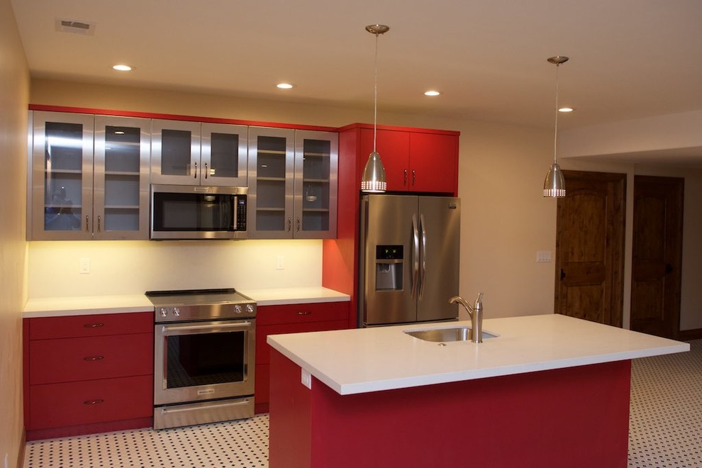 This is an example of a mid-sized contemporary galley eat-in kitchen in San Diego with an undermount sink, flat-panel cabinets, red cabinets, solid surface benchtops, stainless steel appliances, porcelain floors, with island and multi-coloured floor.
