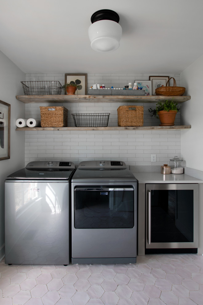 Inspiration for a small transitional single-wall dedicated laundry room in Nashville with beaded inset cabinets, beige cabinets, quartz benchtops, white splashback, subway tile splashback, white walls, porcelain floors, a side-by-side washer and dryer, pink floor and white benchtop.