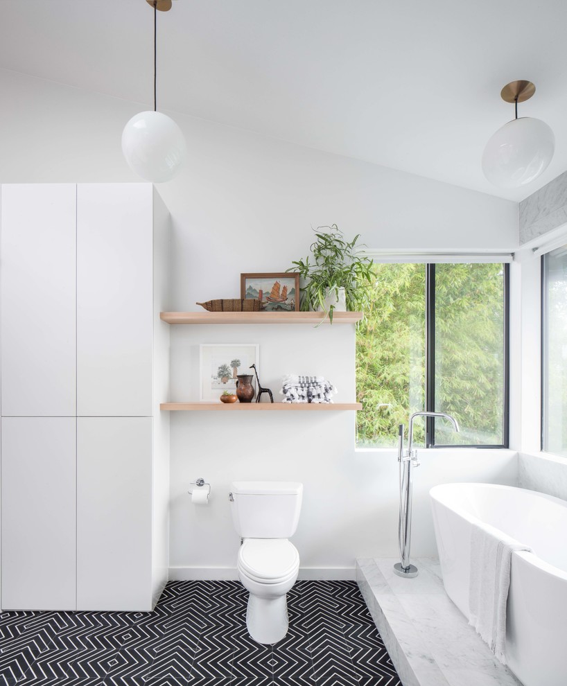 Design ideas for a large modern kids bathroom in Los Angeles with flat-panel cabinets, beige cabinets, a freestanding tub, an open shower, a two-piece toilet, white tile, marble, white walls, cement tiles, a vessel sink, black floor and an open shower.